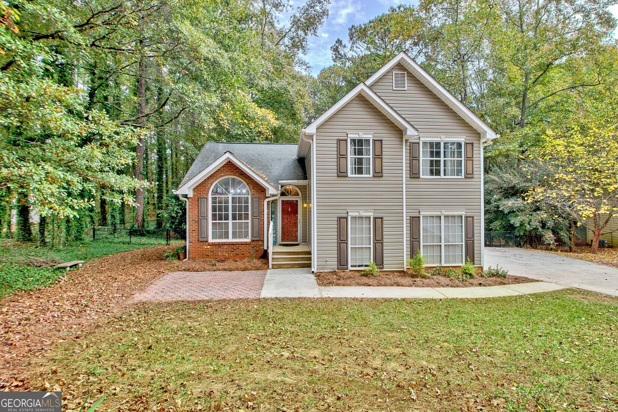 a front view of a house with a yard