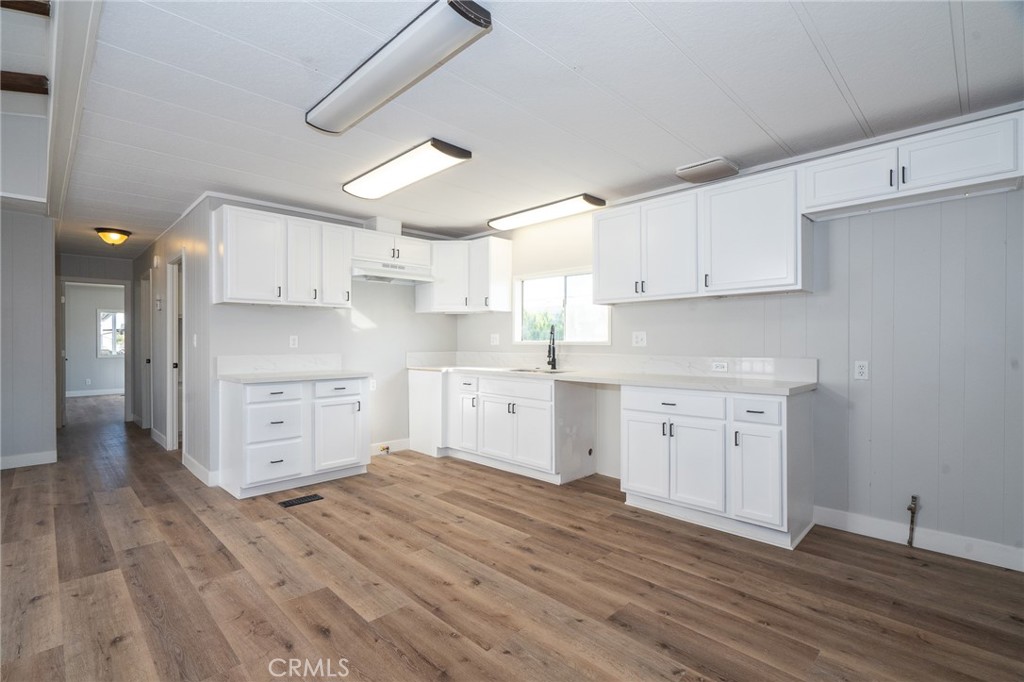 a kitchen with stainless steel appliances a stove refrigerator sink and cabinets