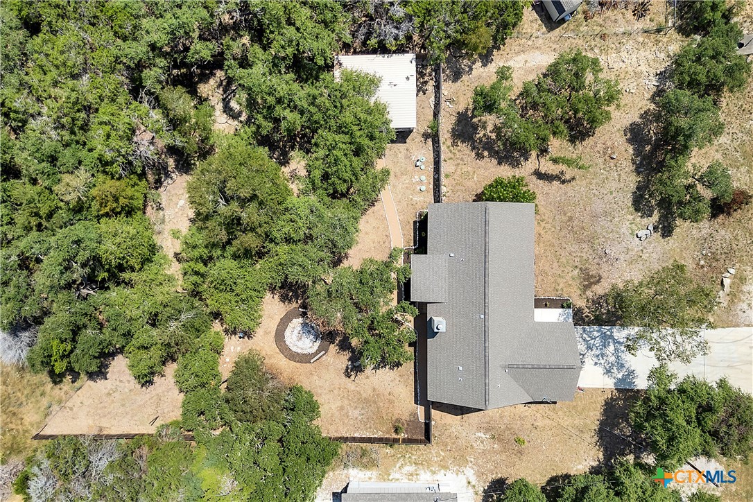 an aerial view of a house with yard