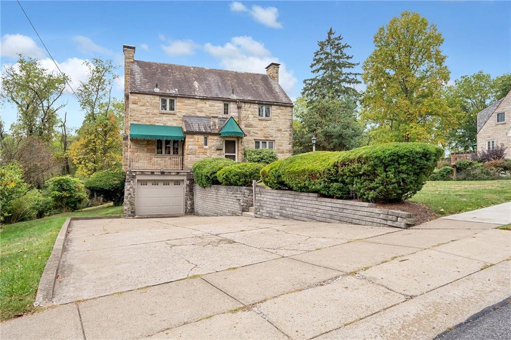 a front view of a house with a yard and a garage