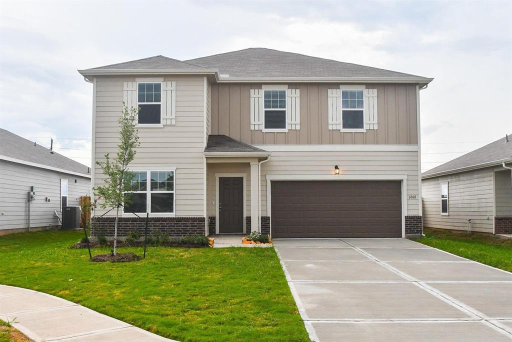 a front view of a house with a garden and yard