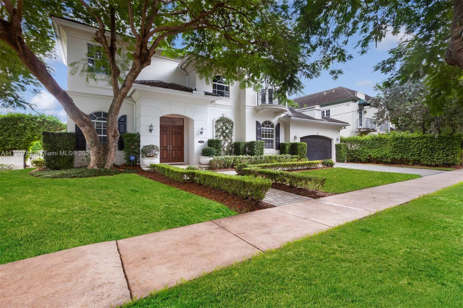 a front view of house with yard and green space