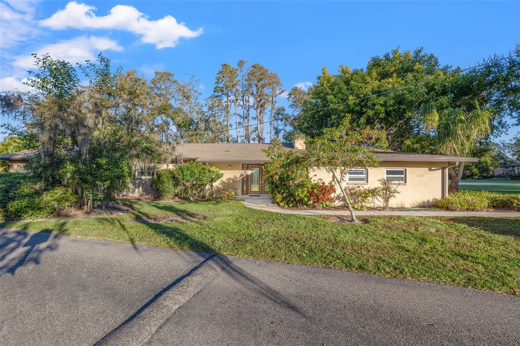 a view of a house with a yard and tree s