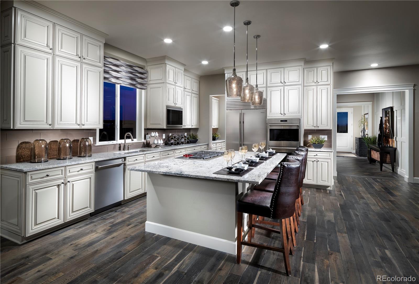 a kitchen with kitchen island granite countertop a sink cabinets and wooden floor