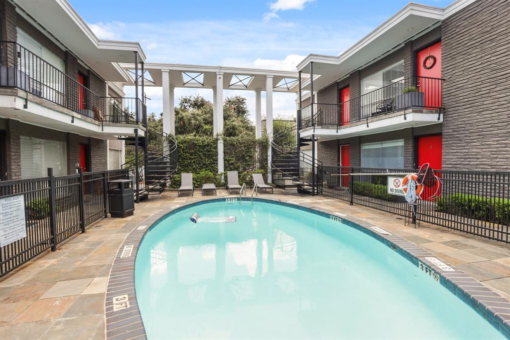 a swimming pool with outdoor seating