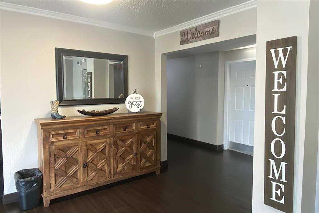 a utility room with mirror and furniture