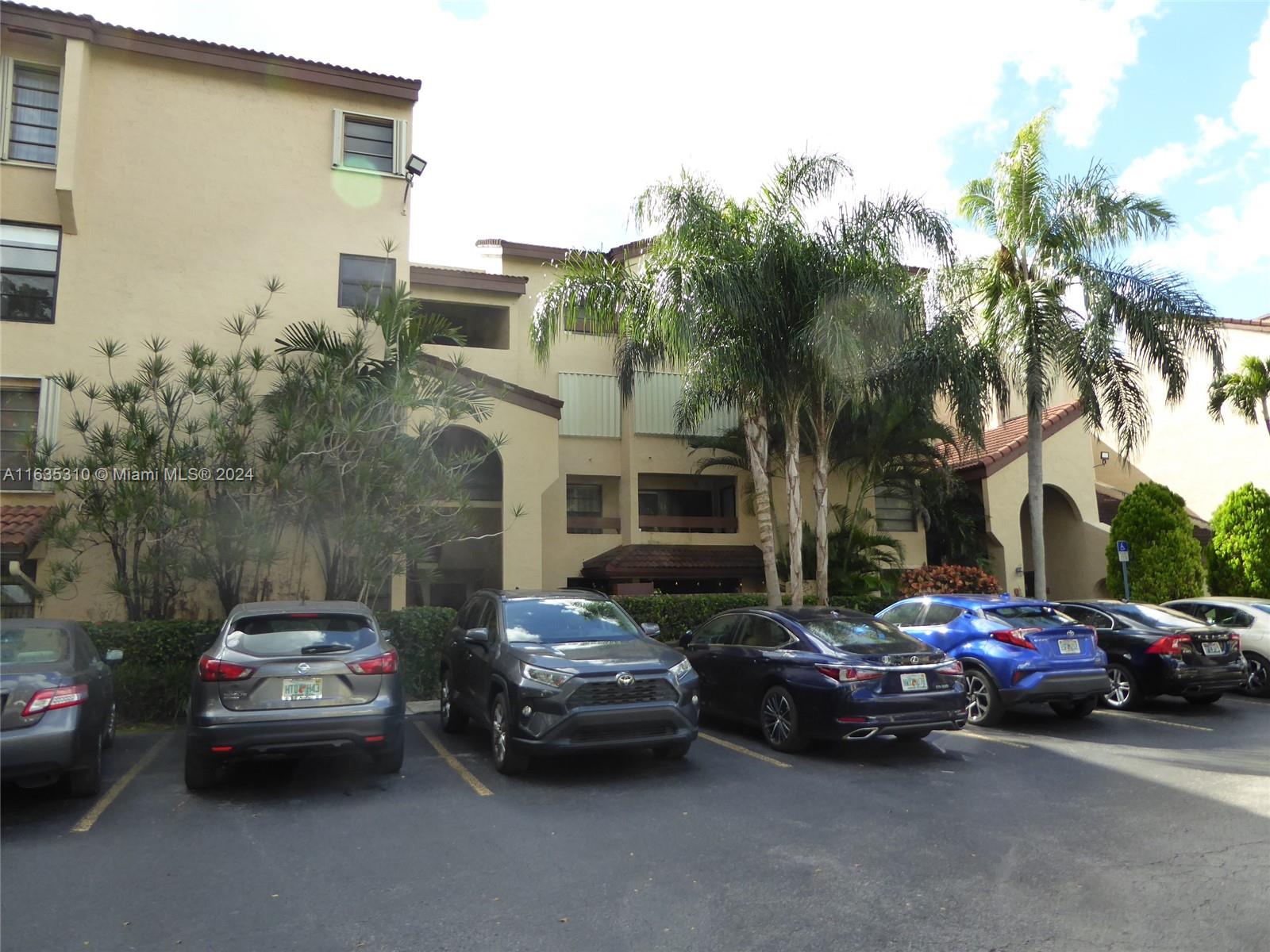 a view of cars parked in front of a house