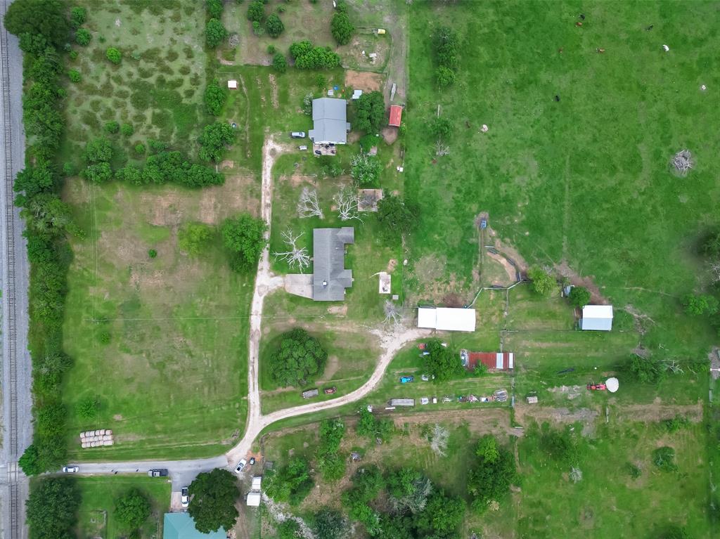 an aerial view of residential houses with outdoor space and street view