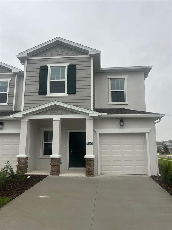 a front view of a house with garage