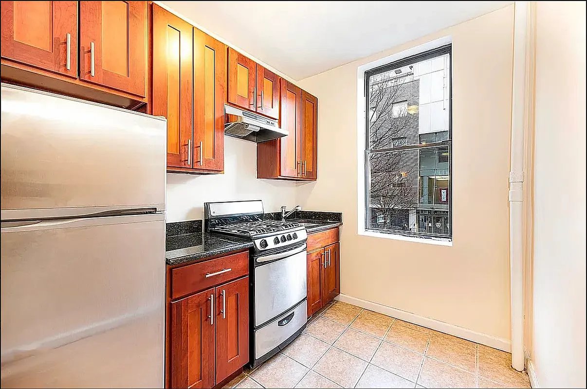 a kitchen with stainless steel appliances granite countertop a refrigerator and a stove top oven