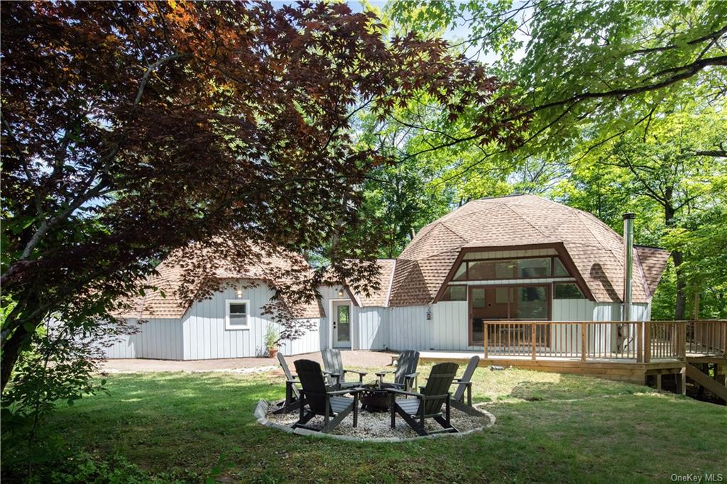 a view of a house with backyard sitting area and garden