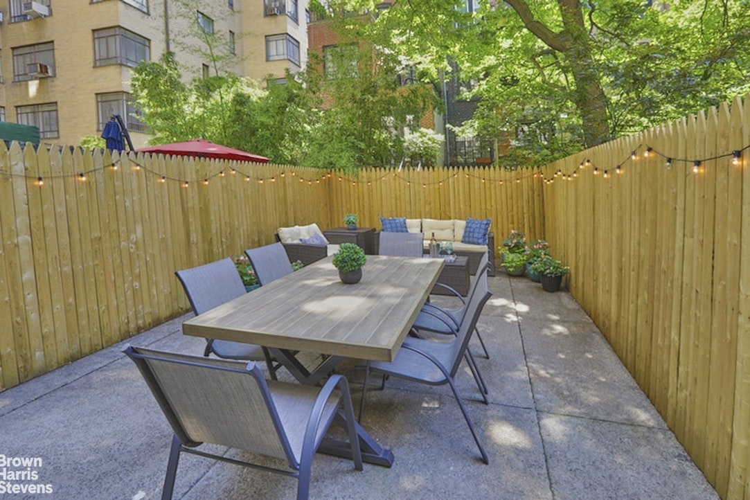 a backyard of a house with table and chairs