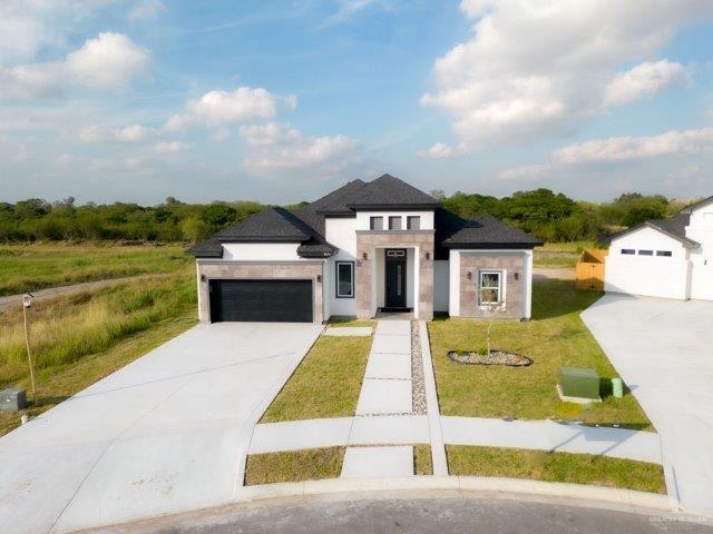 View of front facade with a front lawn and a garage