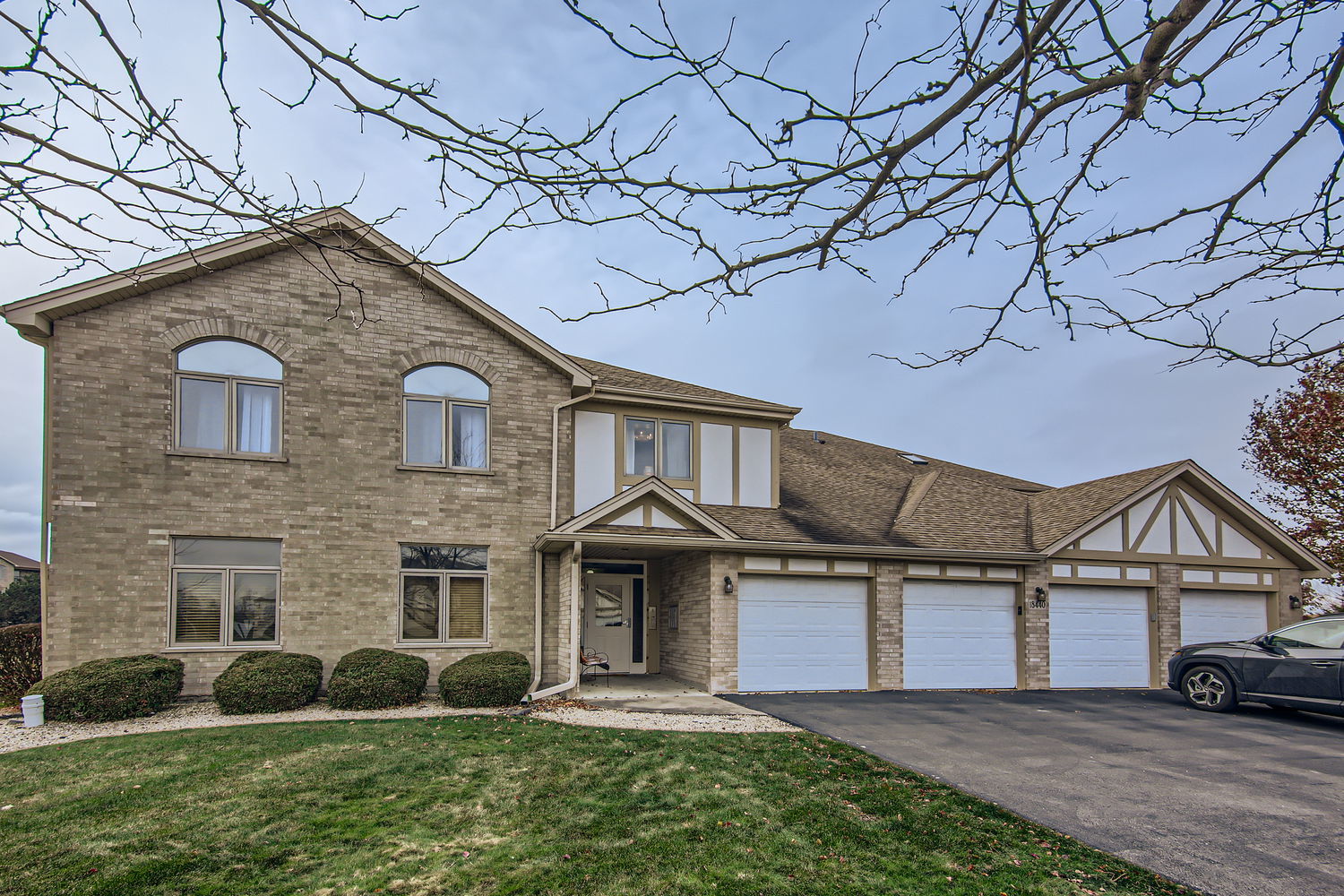 a front view of a house with a yard and garage