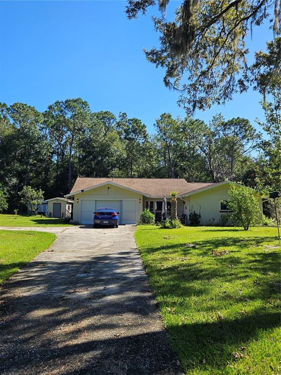 a front view of a house with a yard and trees