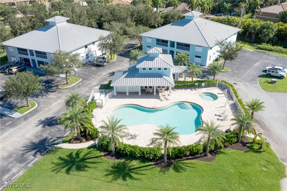 an aerial view of a house with swimming pool and outdoor seating