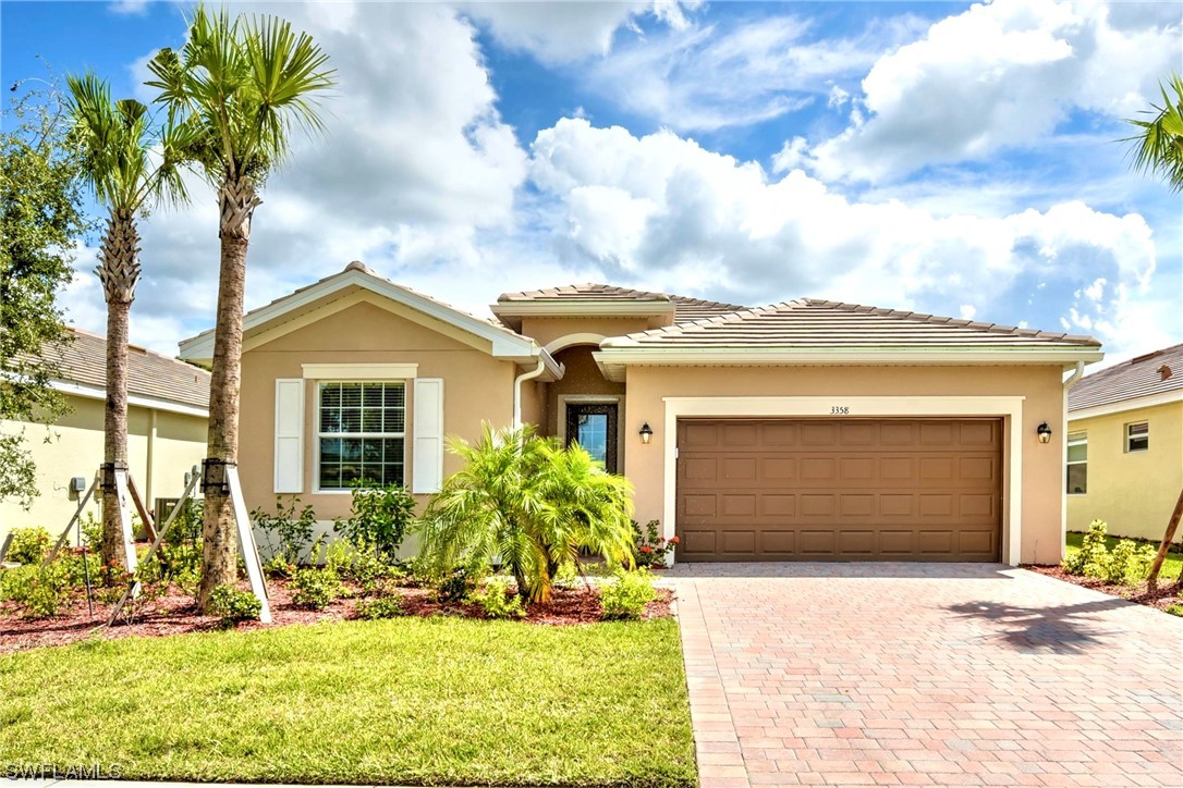 a front view of a house with a yard and garage