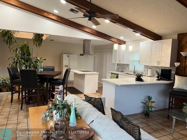 a kitchen with a table chairs and white appliances