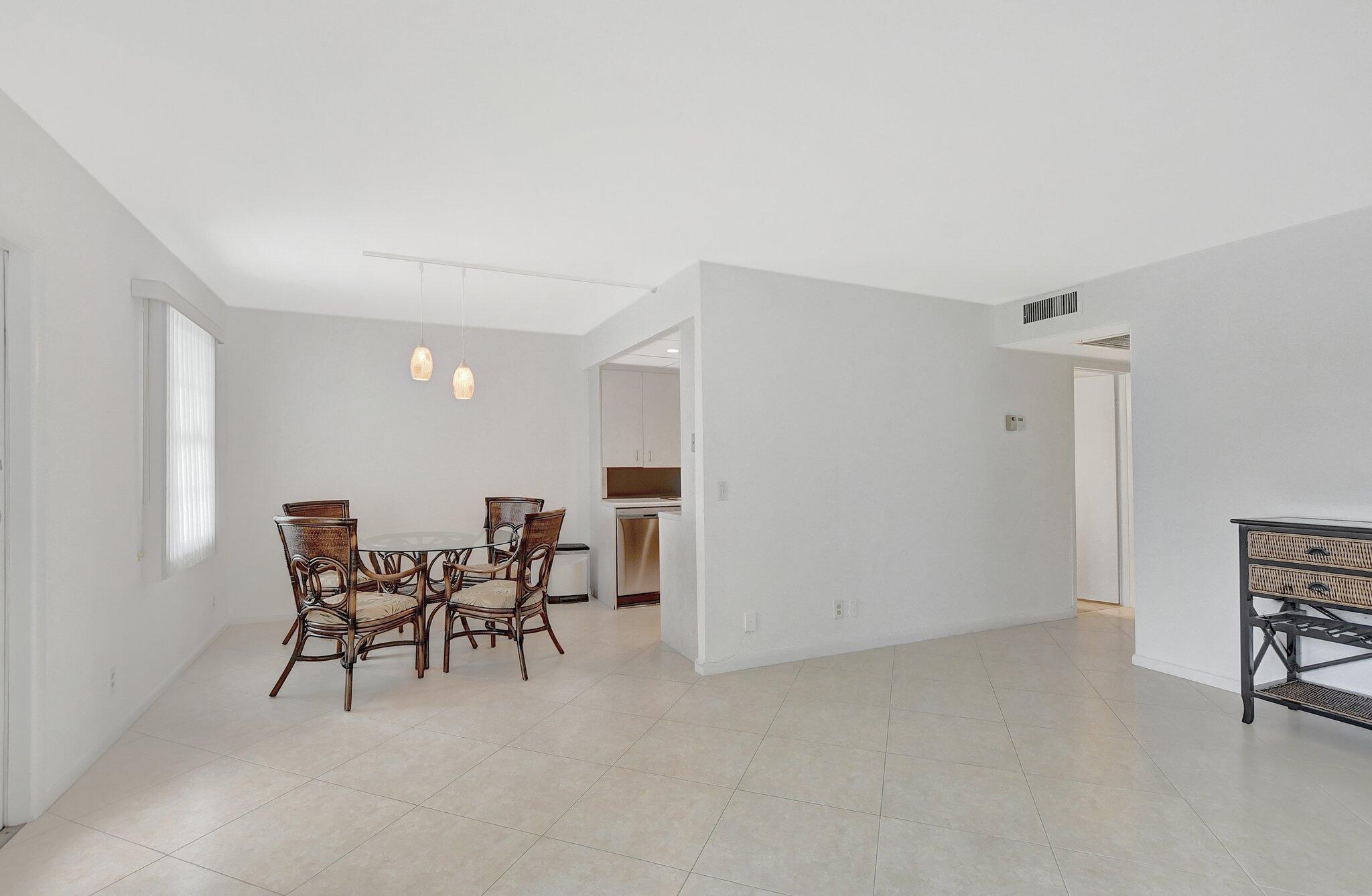 a view of a livingroom with furniture and kitchen