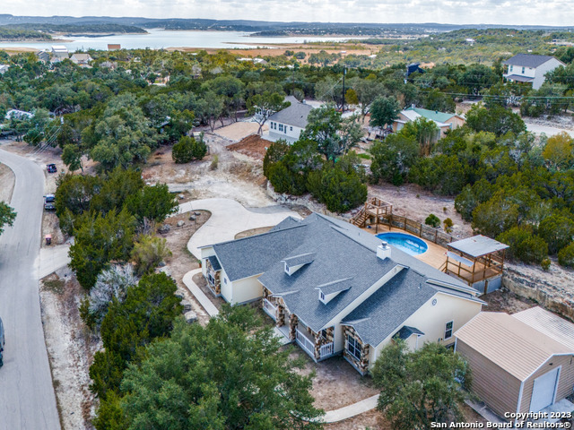 an aerial view of a house with a yard