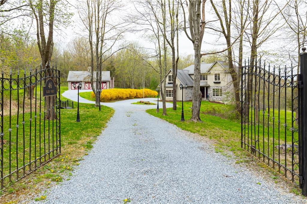 a view of a park with iron fence