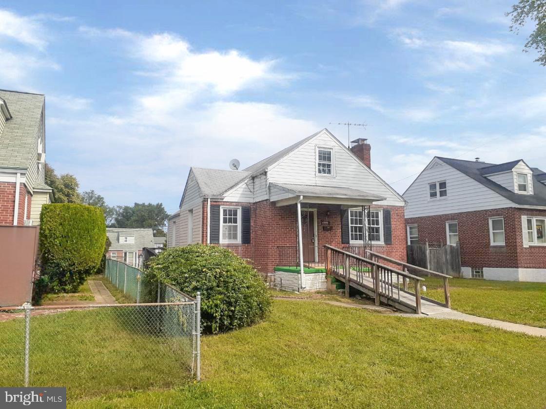 a view of a house with a big yard and potted plants