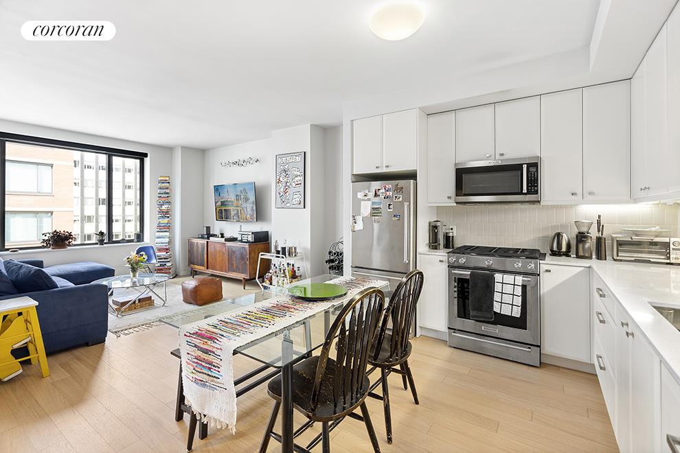 a kitchen with a table chairs microwave and stove top oven