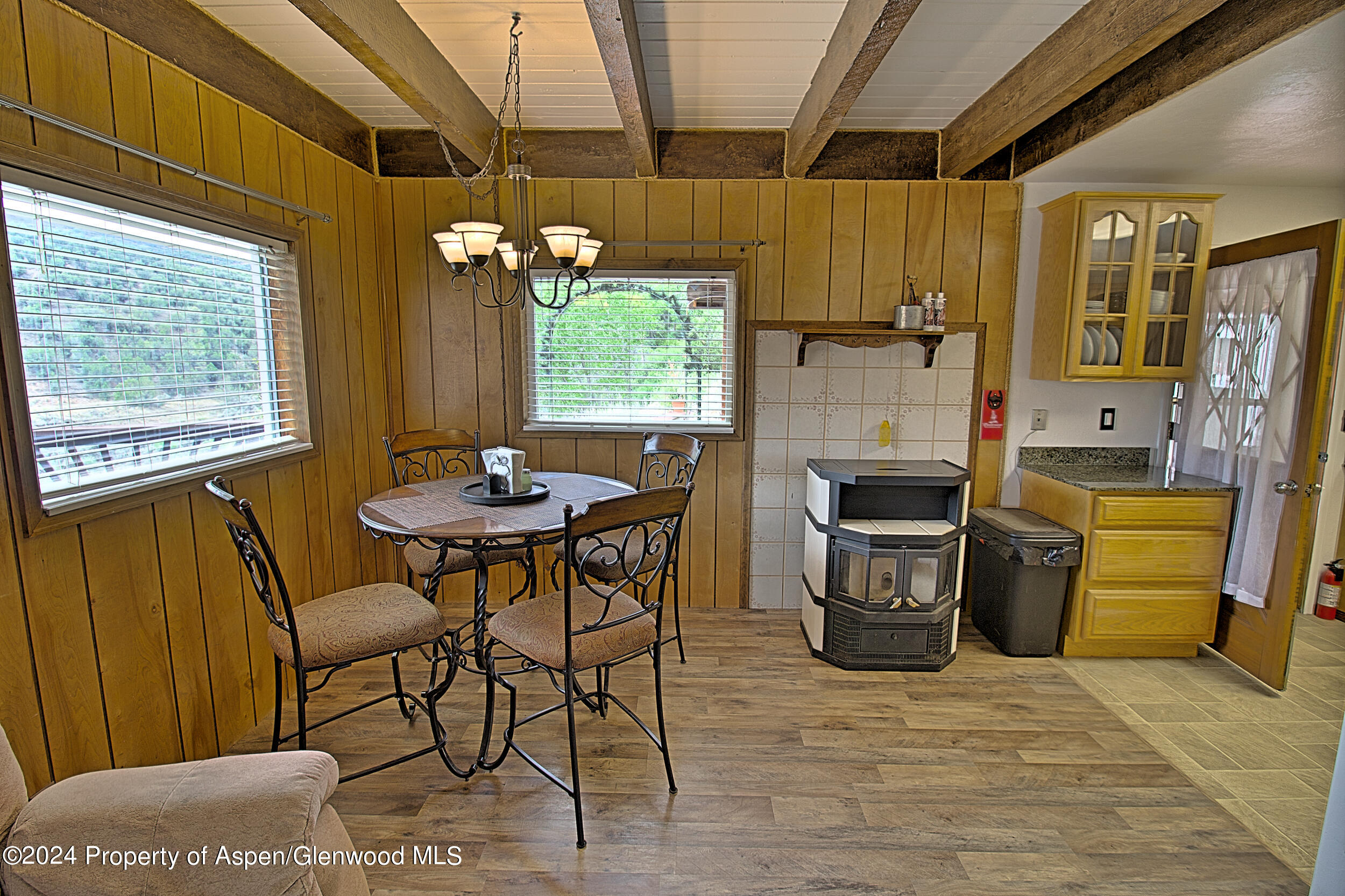 a dining room with a wooden table and chairs