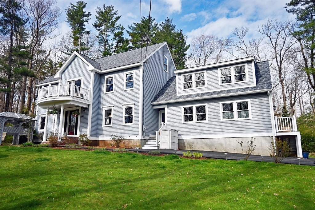 a front view of house with yard and green space