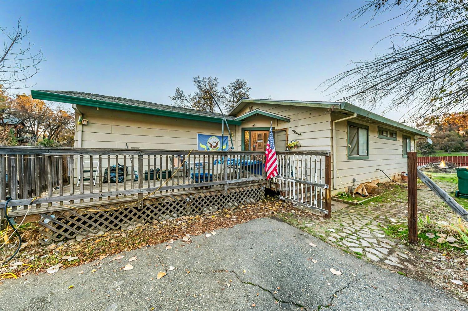 a view of a house with a wooden fence