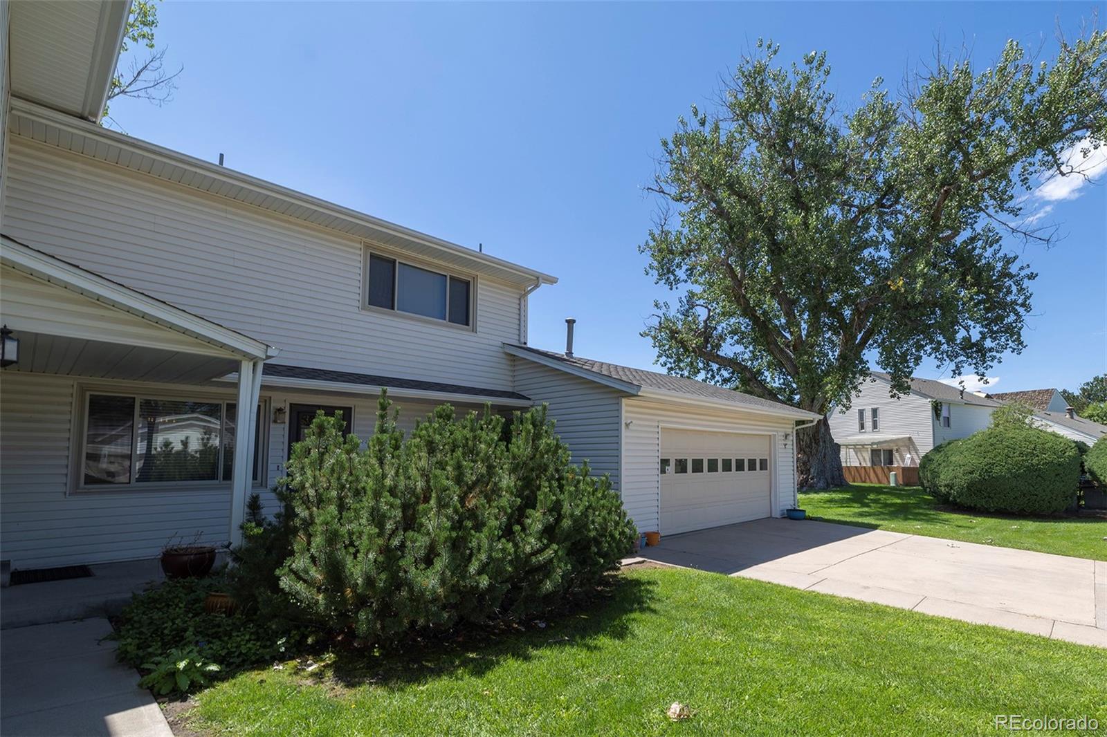 a view of a house with a yard and plants