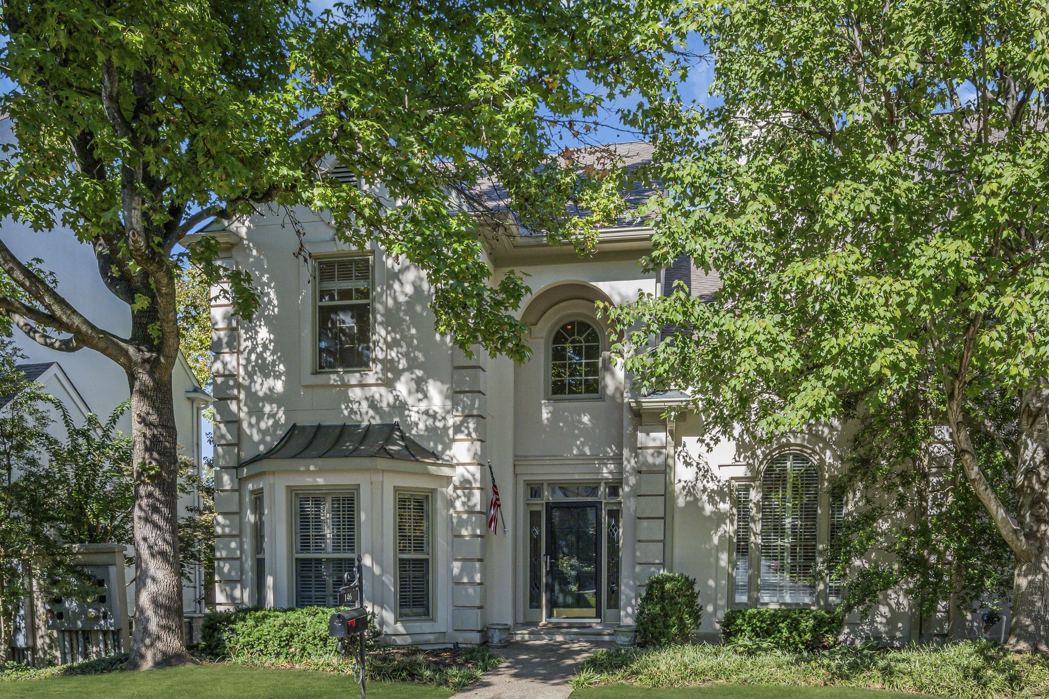 a front view of a house with garden