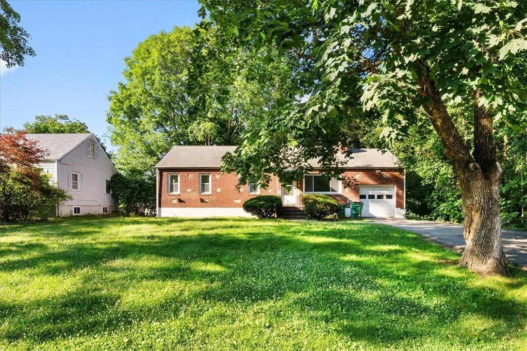 View of front of home featuring a garage and a front lawn