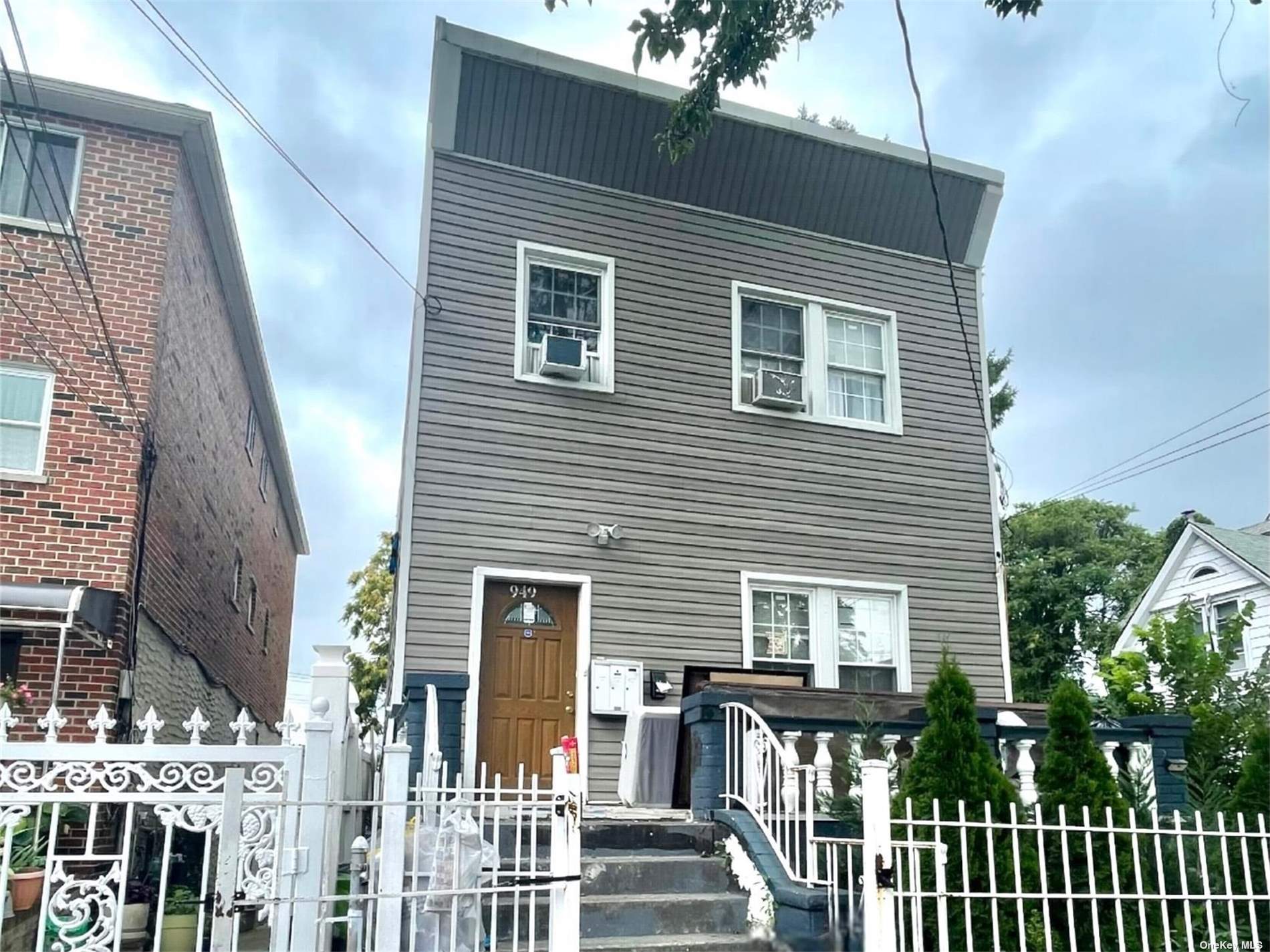 a view of a house with wooden deck and furniture