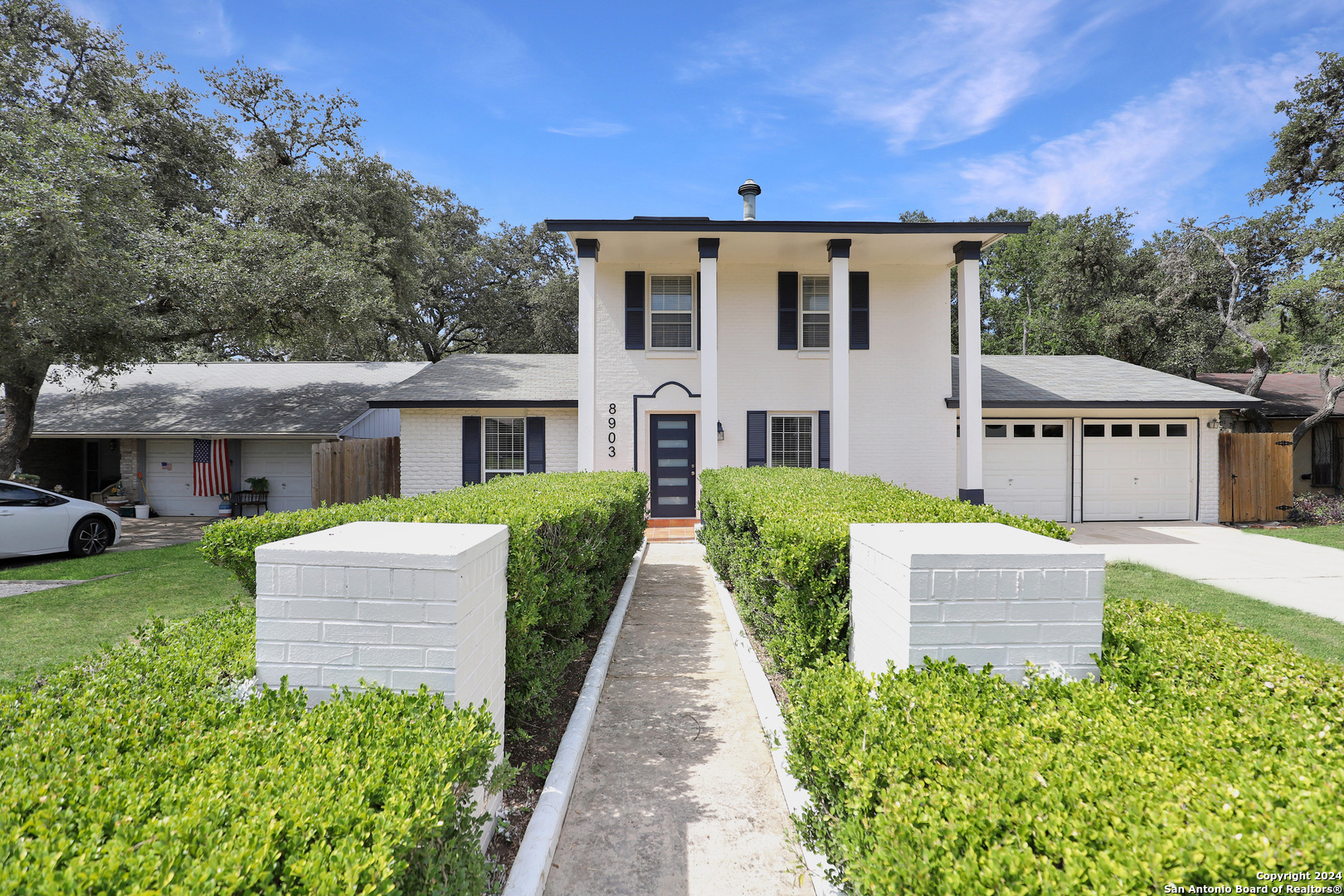 a front view of a house with garden