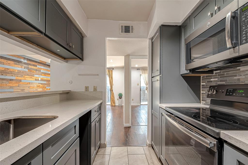 a kitchen with a stove microwave and a refrigerator