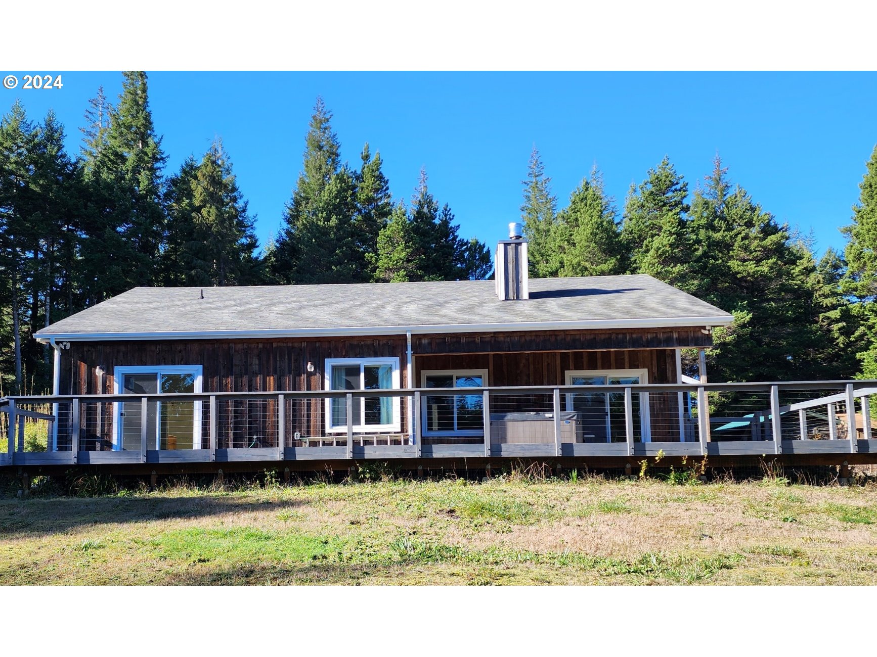 a view of a house with a garden and deck