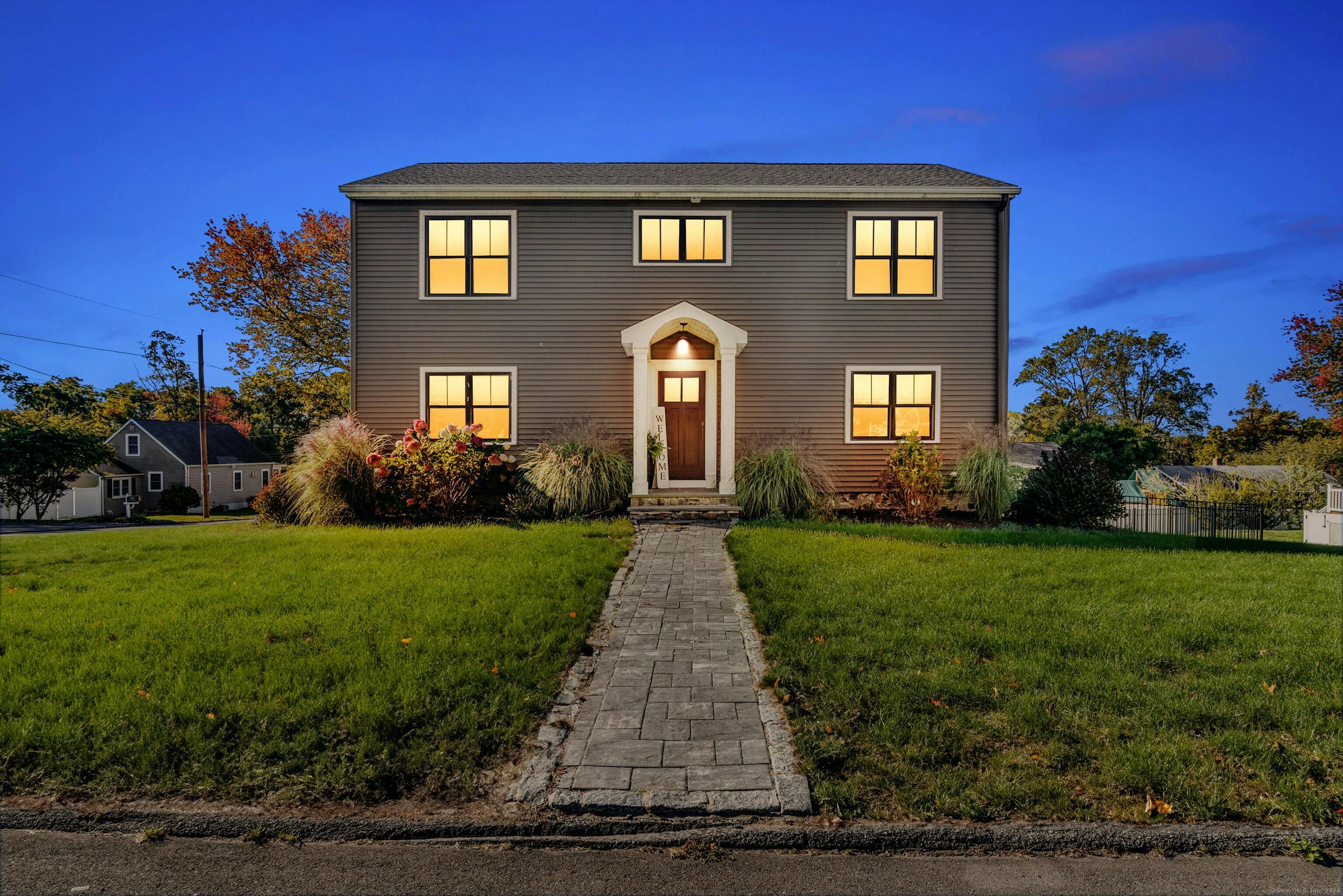 a front view of a house with garden