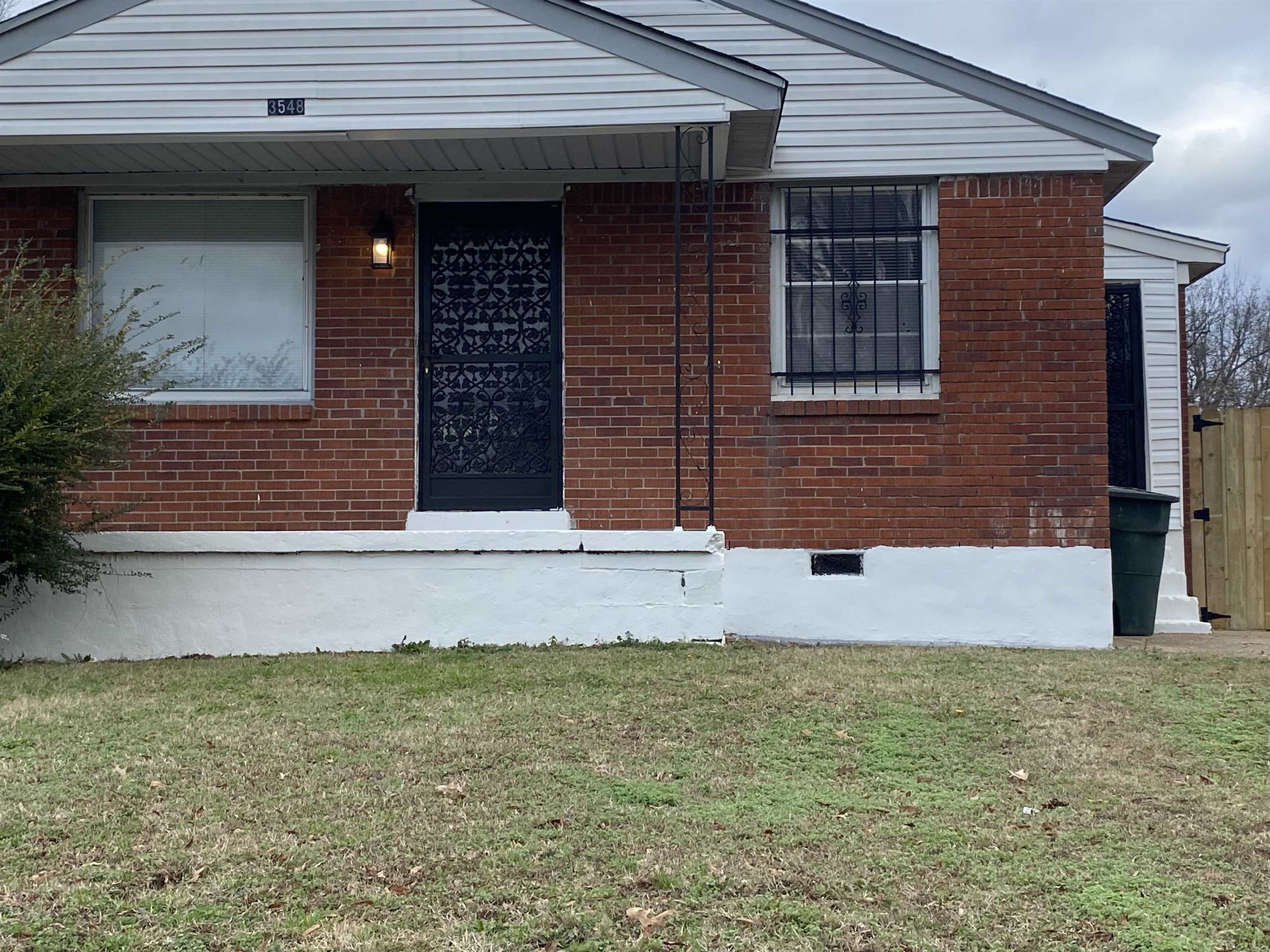 View of exterior entry featuring a yard