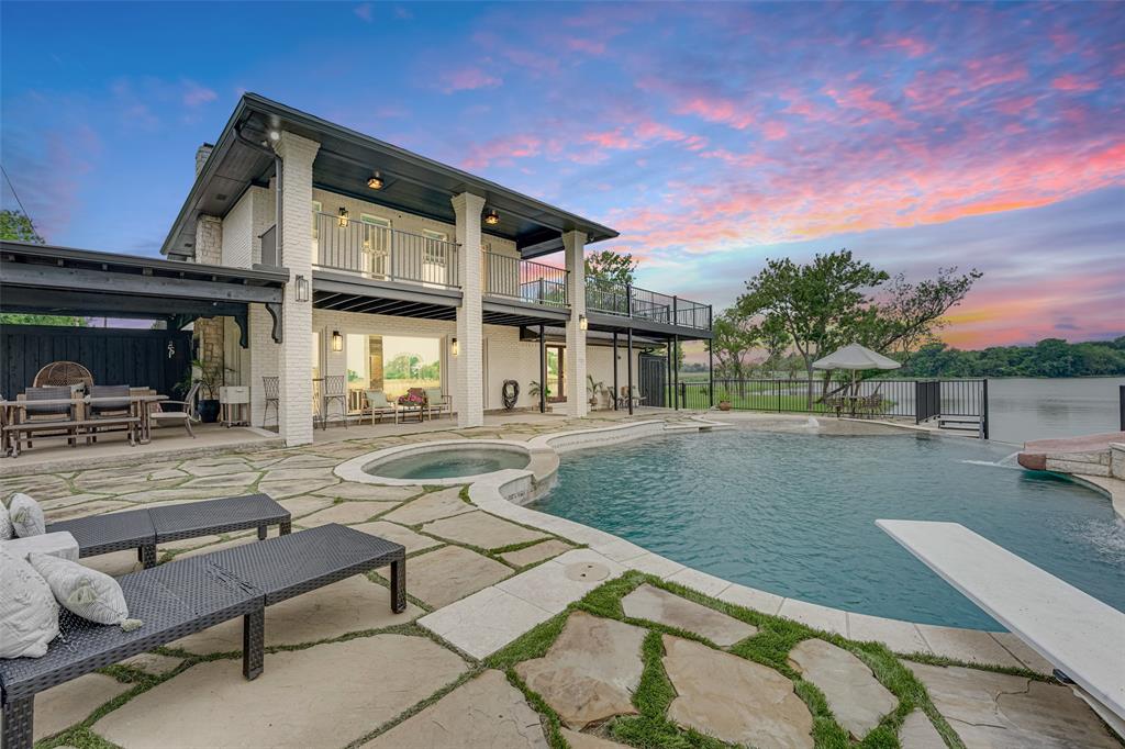 a view of a house with swimming pool and sitting area