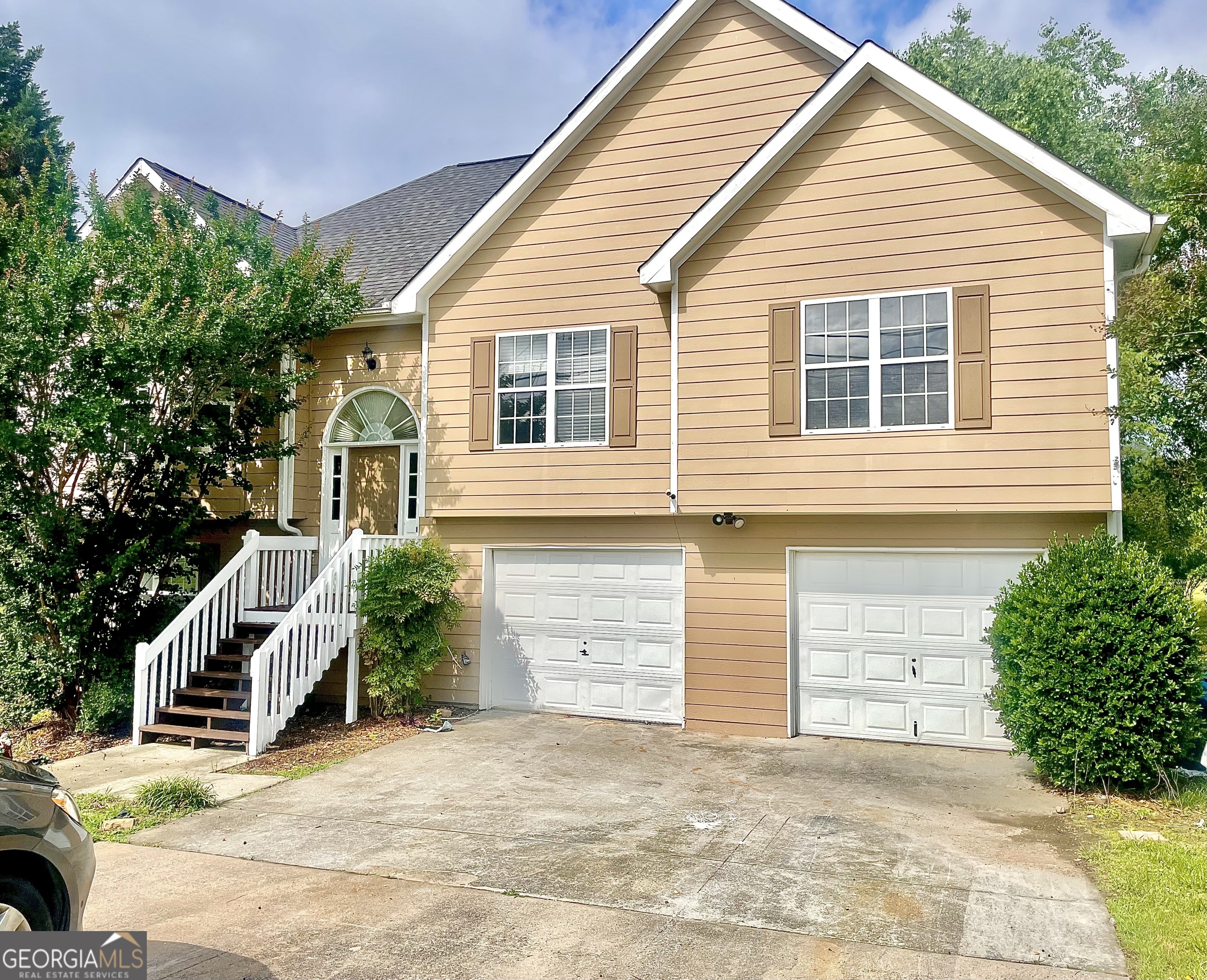 a front view of a house with a yard and garage