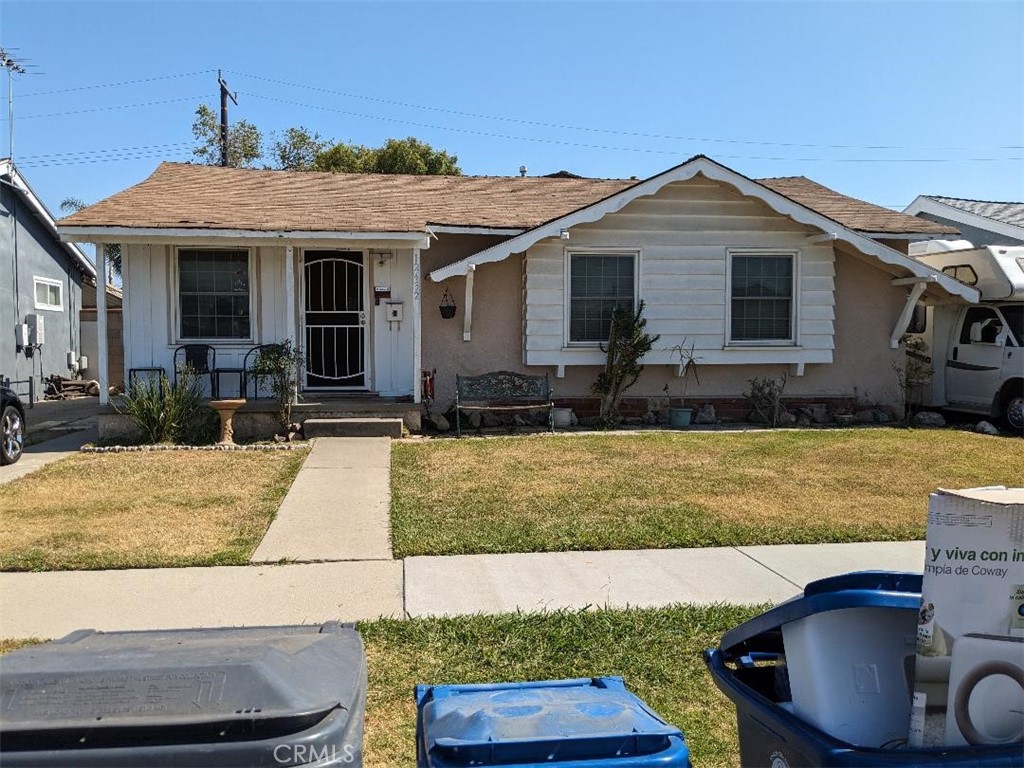 a front view of house with yard outdoor seating and barbeque oven