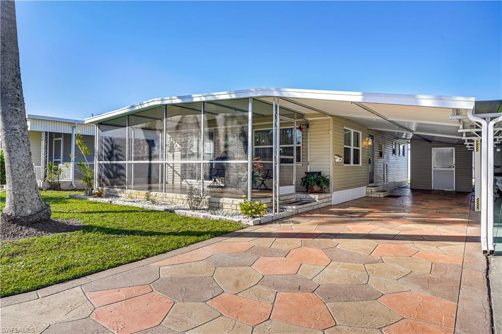 a view of a house with backyard porch and sitting area