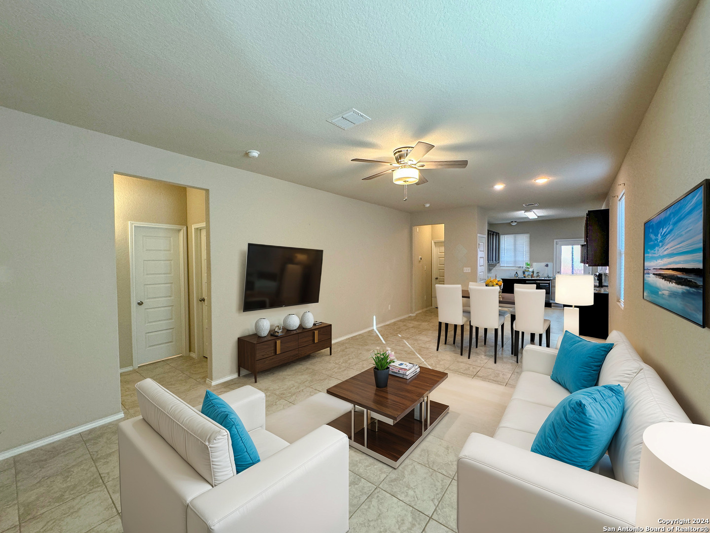 a living room with furniture and a flat screen tv