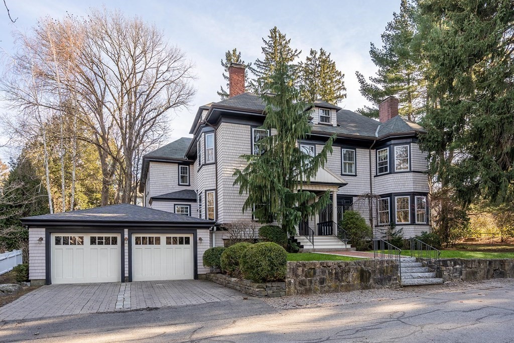 a front view of a house with a garden