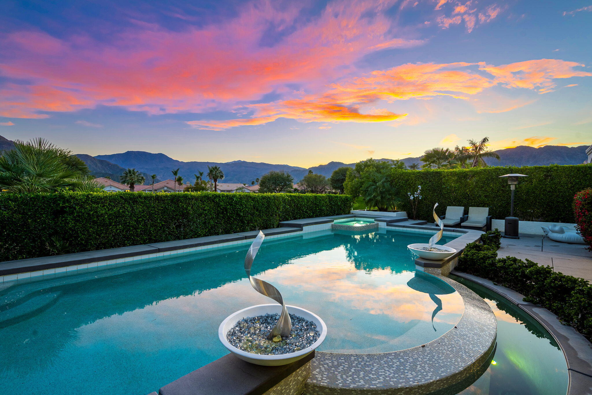 a view of a swimming pool with a patio and a garden