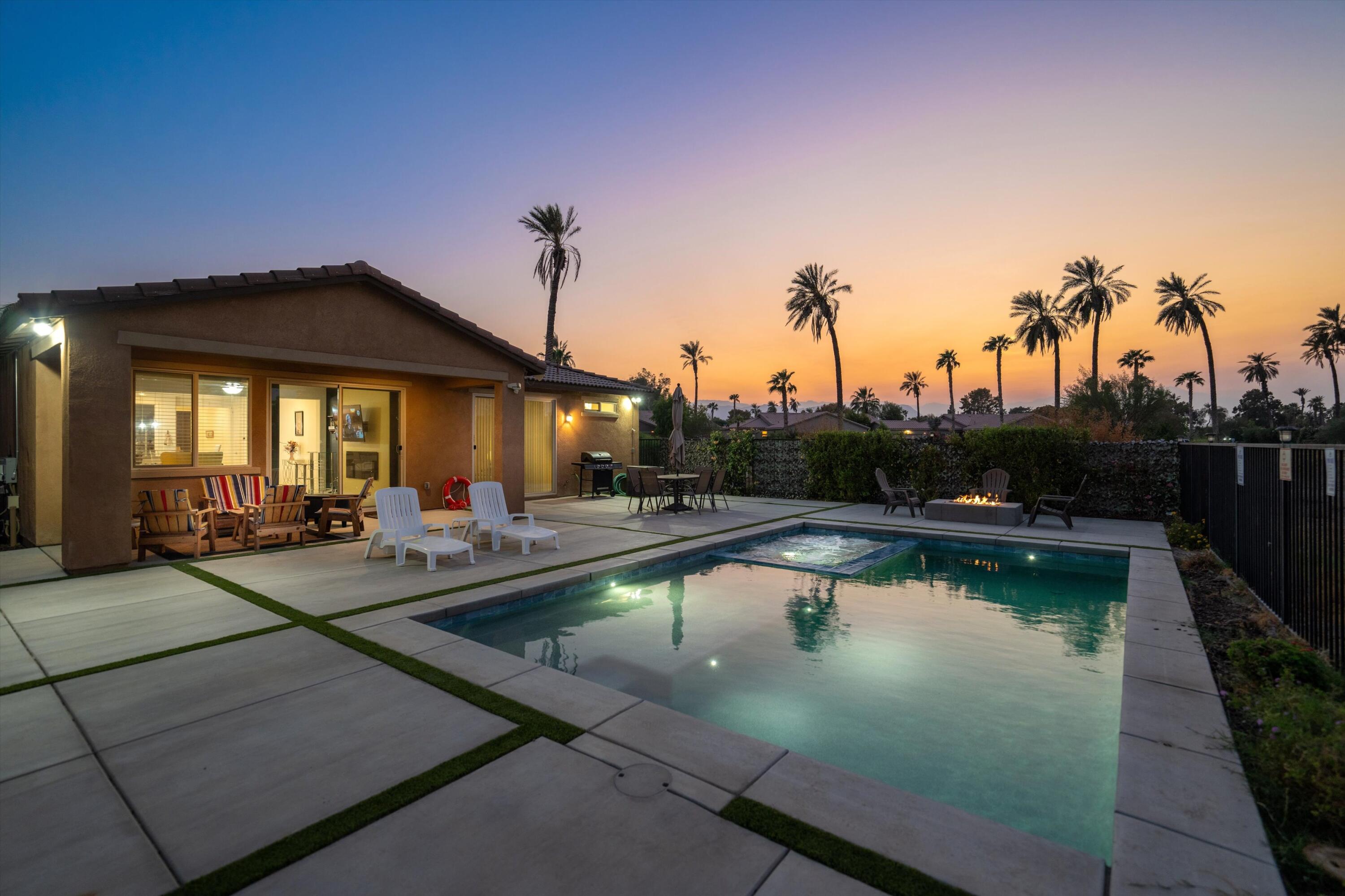 a view of a house with swimming pool and sitting area