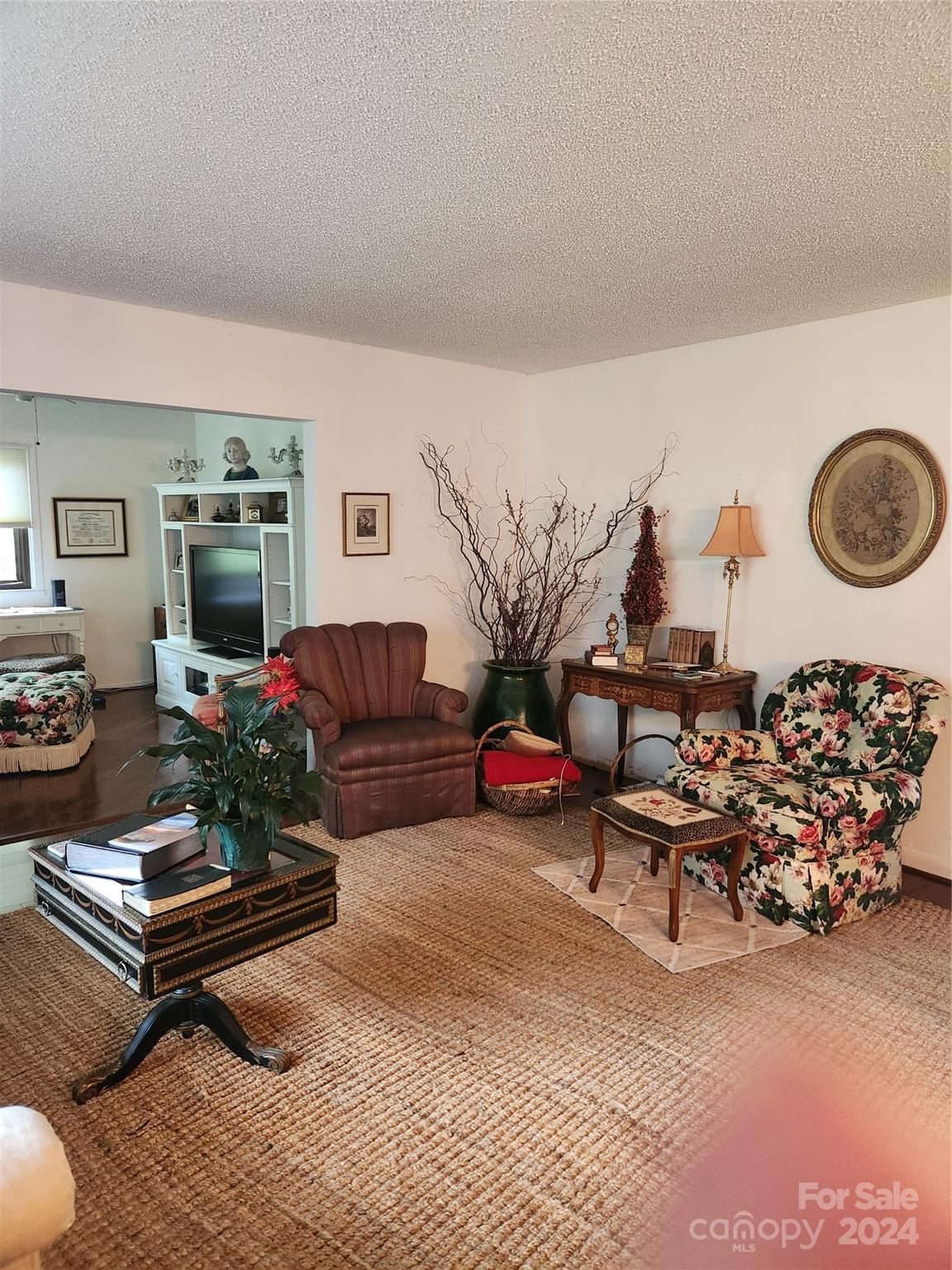 a living room with furniture gym equipment and a rug