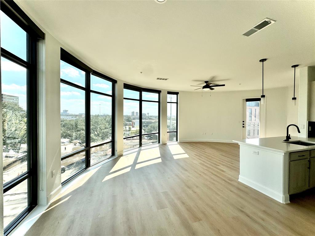 a view of a room with wooden floor and windows