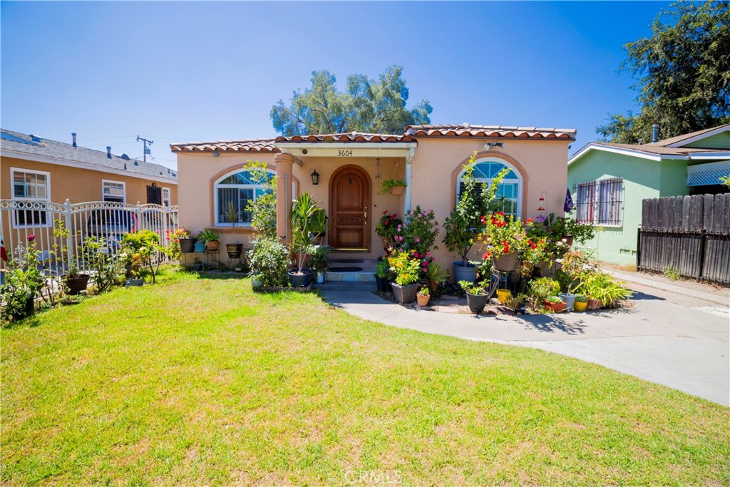 a view of a house with furniture and potted plants